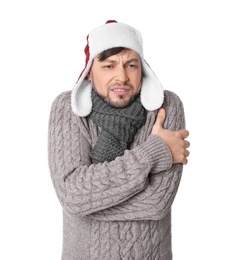 Photo of Man in warm clothes suffering from cold on white background