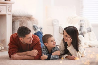 Photo of Happy family with little son spending time together at home. Winter vacation