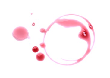 Photo of Red wine rings and drops on white background, top view