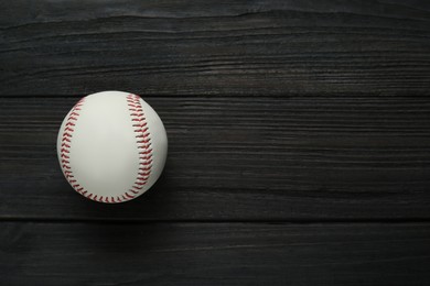 Photo of Baseball ball on black wooden table, top view with space for text. Sports game