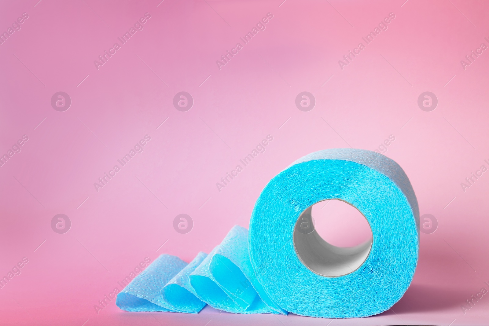 Photo of Roll of toilet paper on color background. Space for text