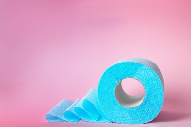 Roll of toilet paper on color background. Space for text