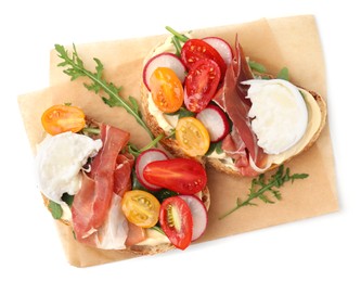 Photo of Delicious sandwiches with burrata cheese, ham, radish and tomatoes isolated on white, top view