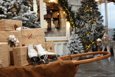 Beautiful Christmas trees, many gift boxes, skates and festive decor indoors. Interior design