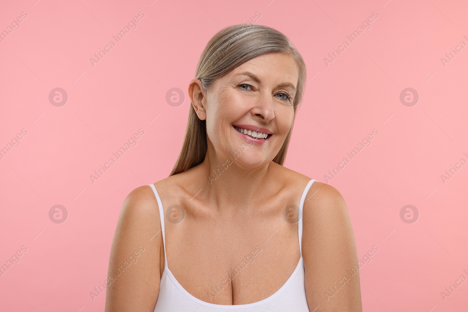 Photo of Beautiful woman with healthy skin on pink background