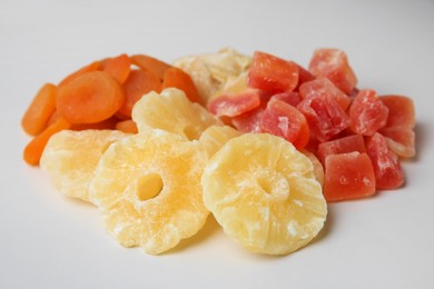 Photo of Pile of different dried fruits on white background, closeup
