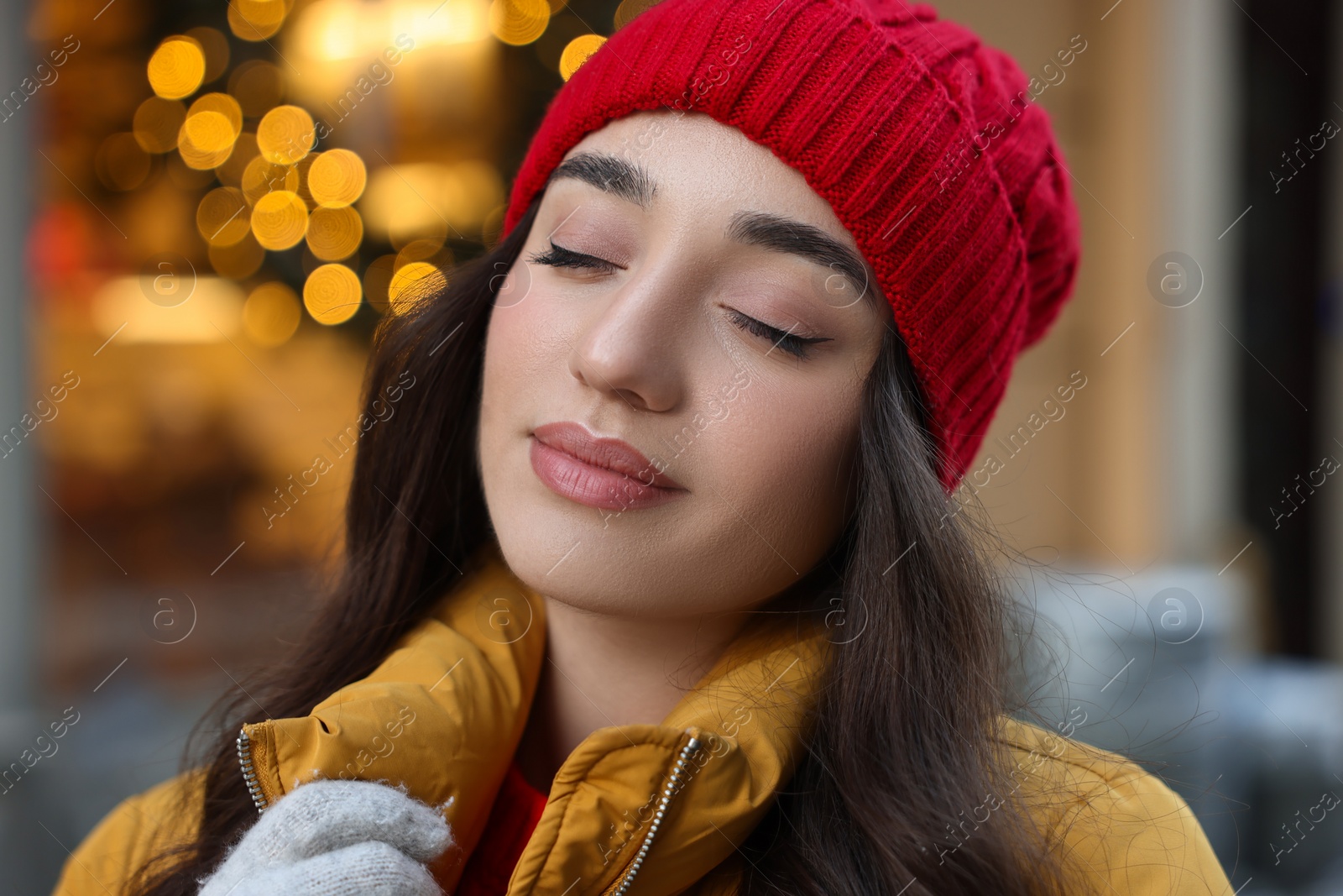 Photo of Portrait of beautiful woman on city street in winter