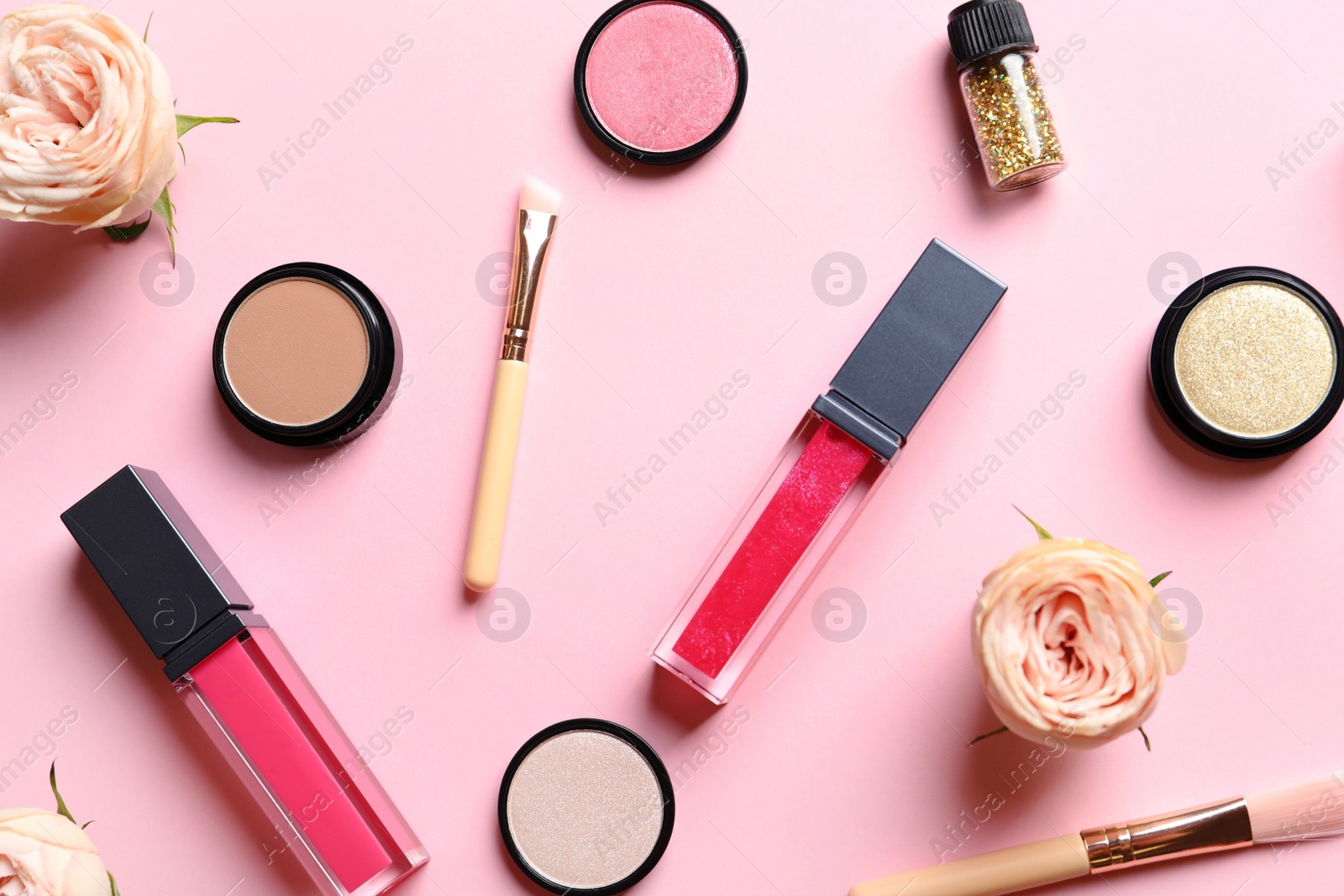 Photo of Beautiful composition with lipsticks and flowers on color background, flat lay