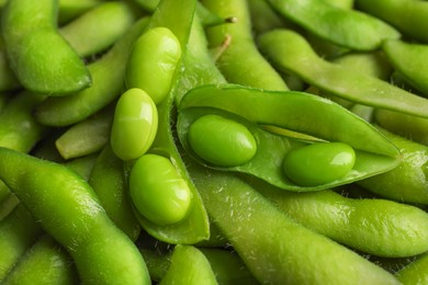Photo of Many green edamame beans in pods as background, closeup