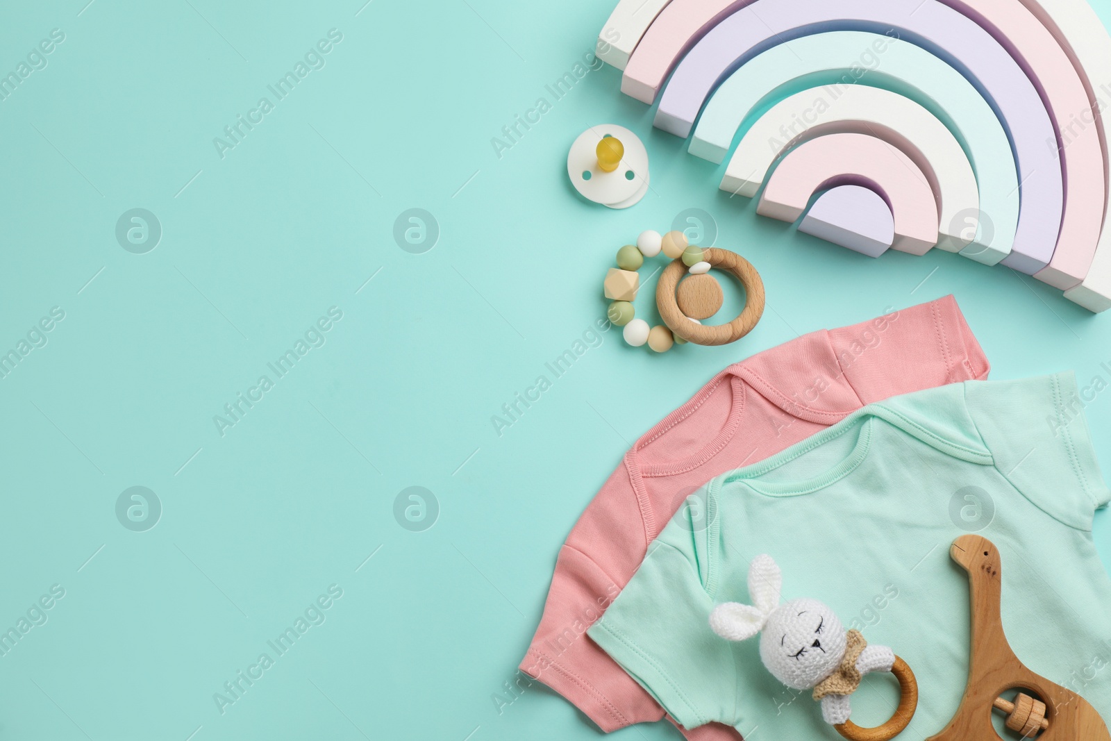 Photo of Flat lay composition with baby clothes and accessories on light blue background, space for text