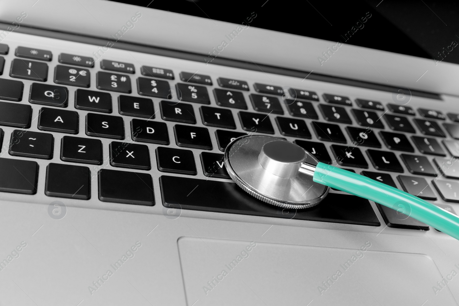 Photo of Laptop with stethoscope, closeup view. Computer repair