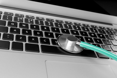 Laptop with stethoscope, closeup view. Computer repair