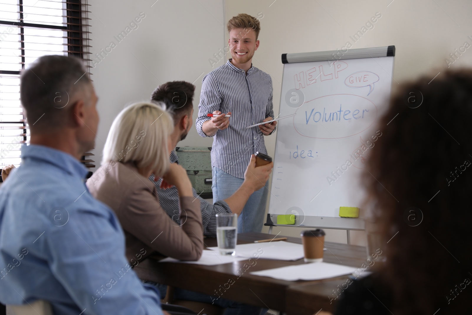 Photo of Portrait of volunteers having meeting in office