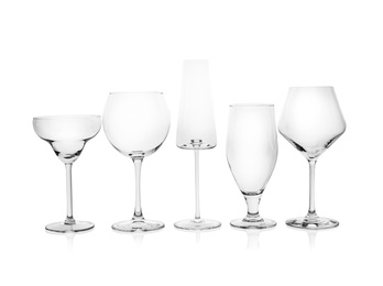 Photo of Set of empty glasses for different drinks on white background