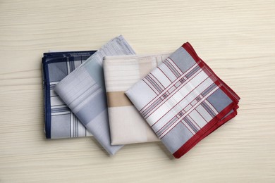 Stylish handkerchiefs on white wooden table, flat lay