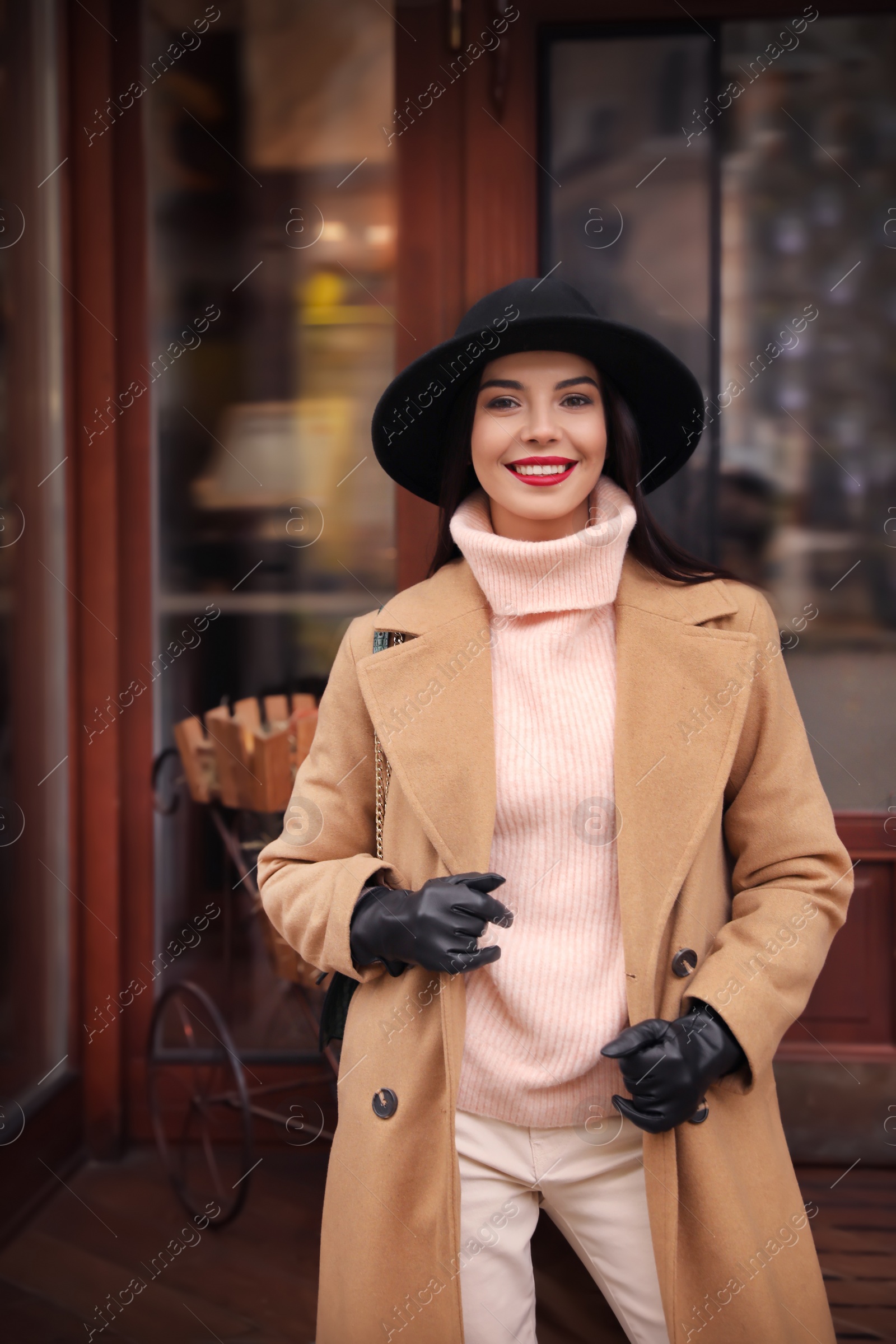 Photo of Young woman wearing stylish clothes on city street. Autumn look