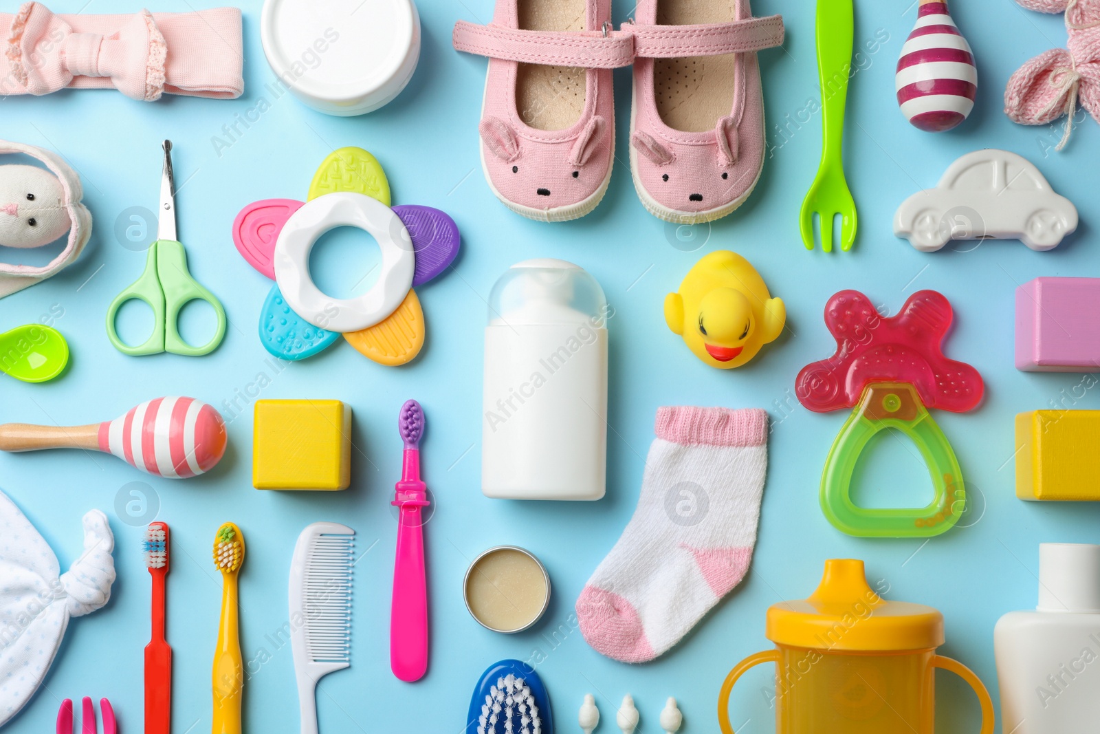 Photo of Flat lay composition with baby accessories and toys on color background