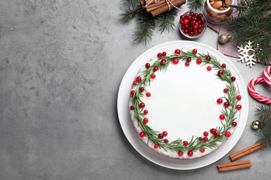 Photo of Flat lay composition with traditional Christmas cake on light grey table. Space for text