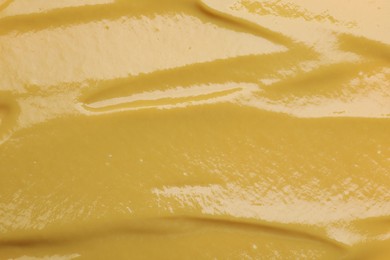 Photo of Texture of delicious mustard as background, top view