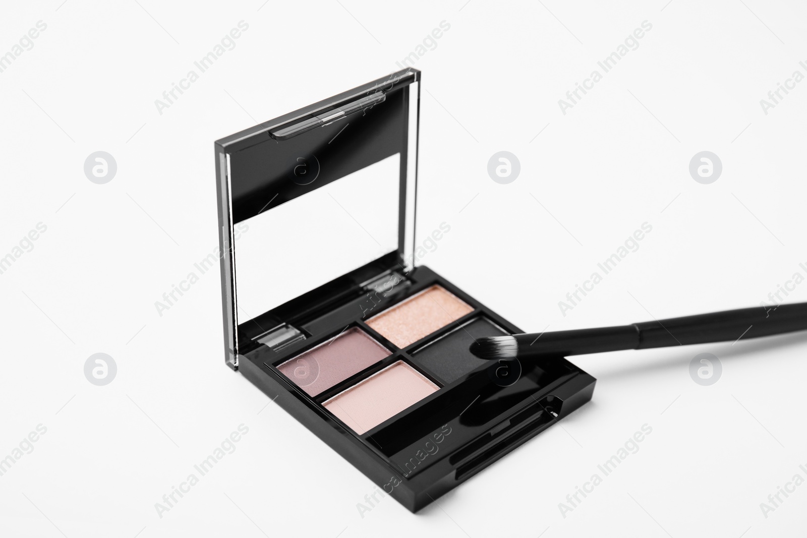 Photo of Eye shadow palette and professional makeup brush on white background