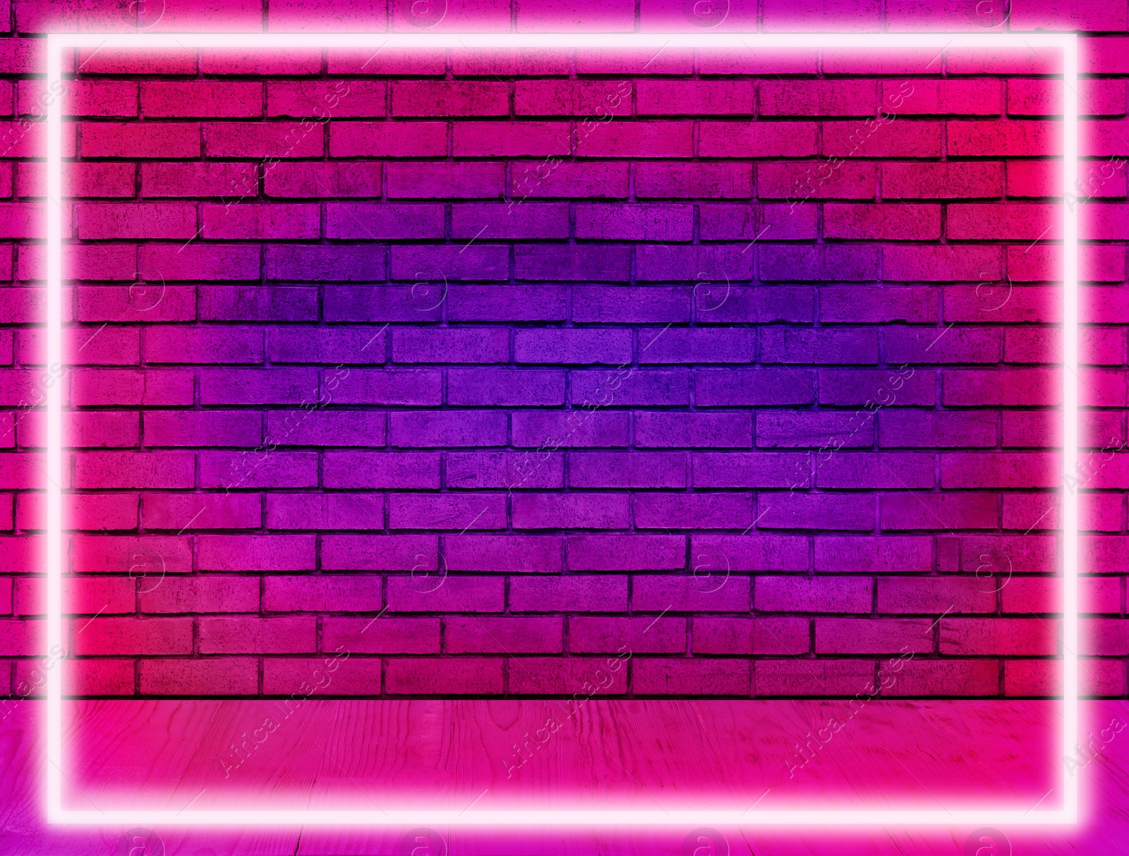 Image of Glowing neon frame in room with brick wall