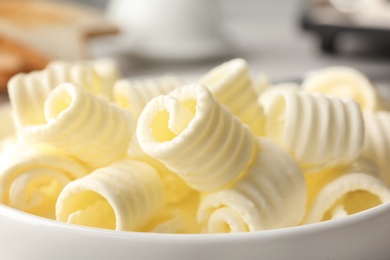 Photo of Plate with tasty butter curls, closeup