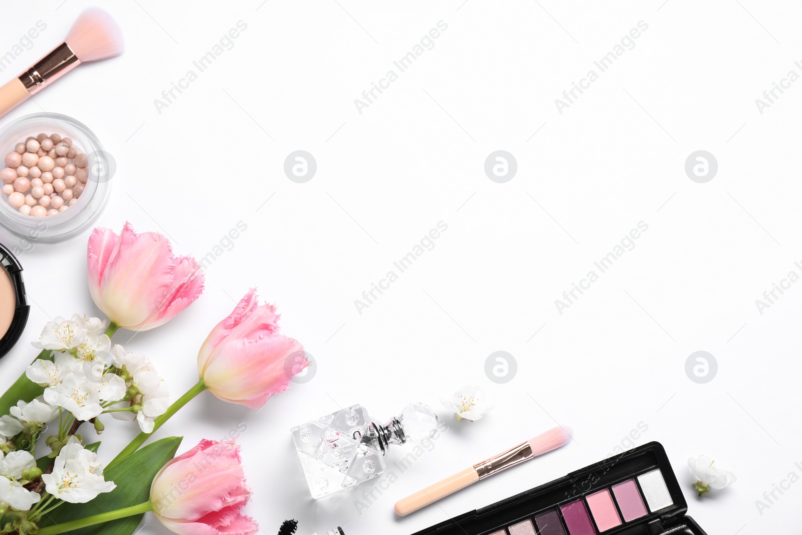 Photo of Flat lay composition with different makeup products and beautiful spring flowers on white background, space for text