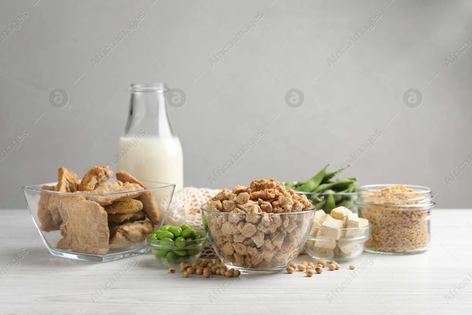 Photo of Different organic soy products on white wooden table