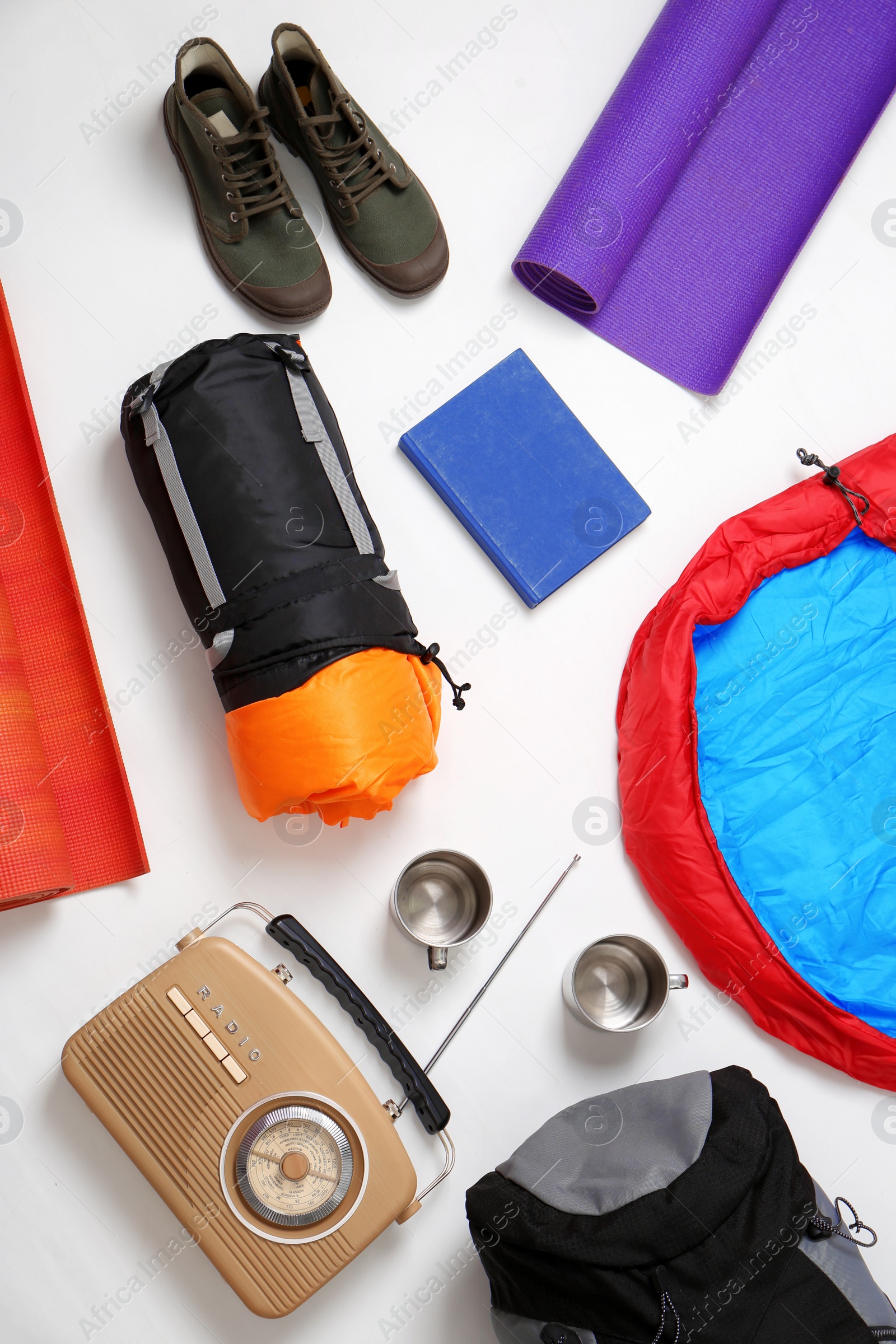 Photo of Flat lay composition with camping equipment on white background