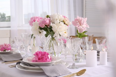 Photo of Stylish table setting with beautiful peonies in dining room