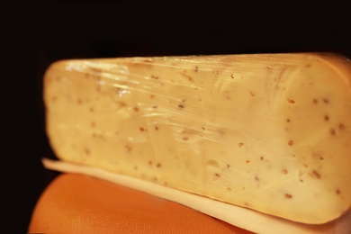 Photo of Delicious cheese in store, closeup. Dairy product