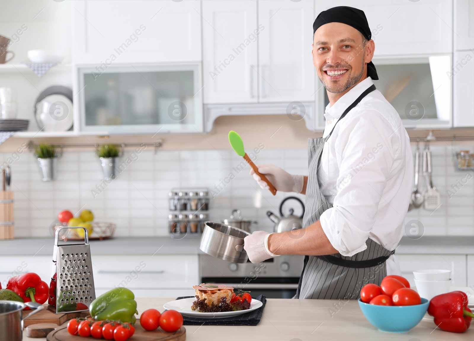 Photo of Professional chef in uniform working at restaurant kitchen