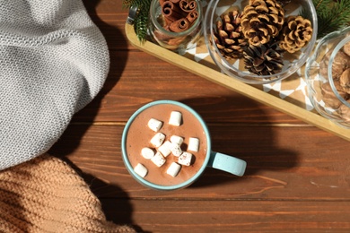 Photo of Flat lay composition with cup of cocoa on wooden background. Winter drink