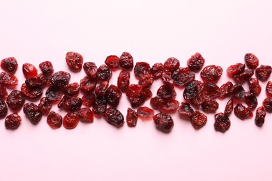 Photo of Cranberries on color background, top view. Dried fruit as healthy snack