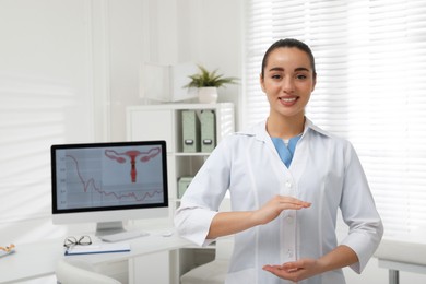 Photo of Young gynecologist holding something in modern clinic