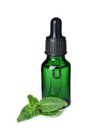 Little bottle of essential oil and mint on white background