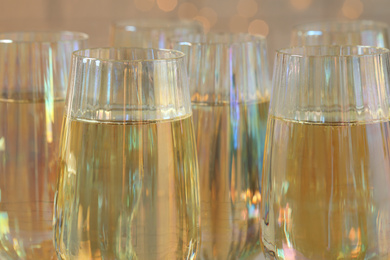 Glasses of champagne on blurred background, closeup