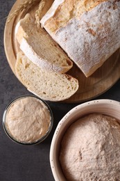 Photo of Fresh sourdough starter, dough and bread on grey table, top view