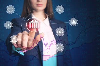 Fintech concept. Woman pointing at icon on virtual screen