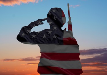 Image of Veterans Day. Military man on sunset outdoors and flag of USA, double exposure