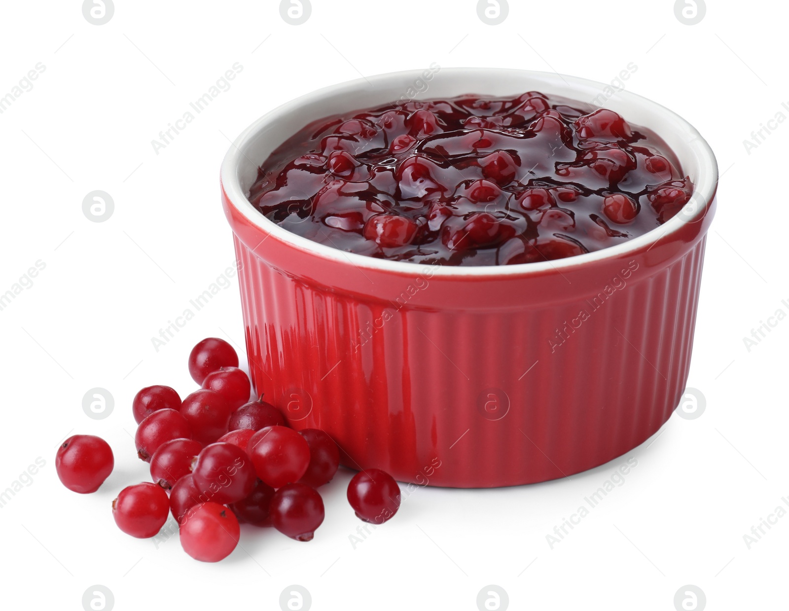 Photo of Cranberry sauce in bowl and fresh berries isolated on white