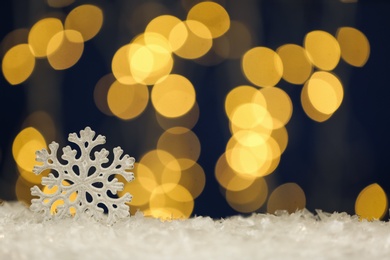 Beautiful decorative snowflake against blurred festive lights, space for text