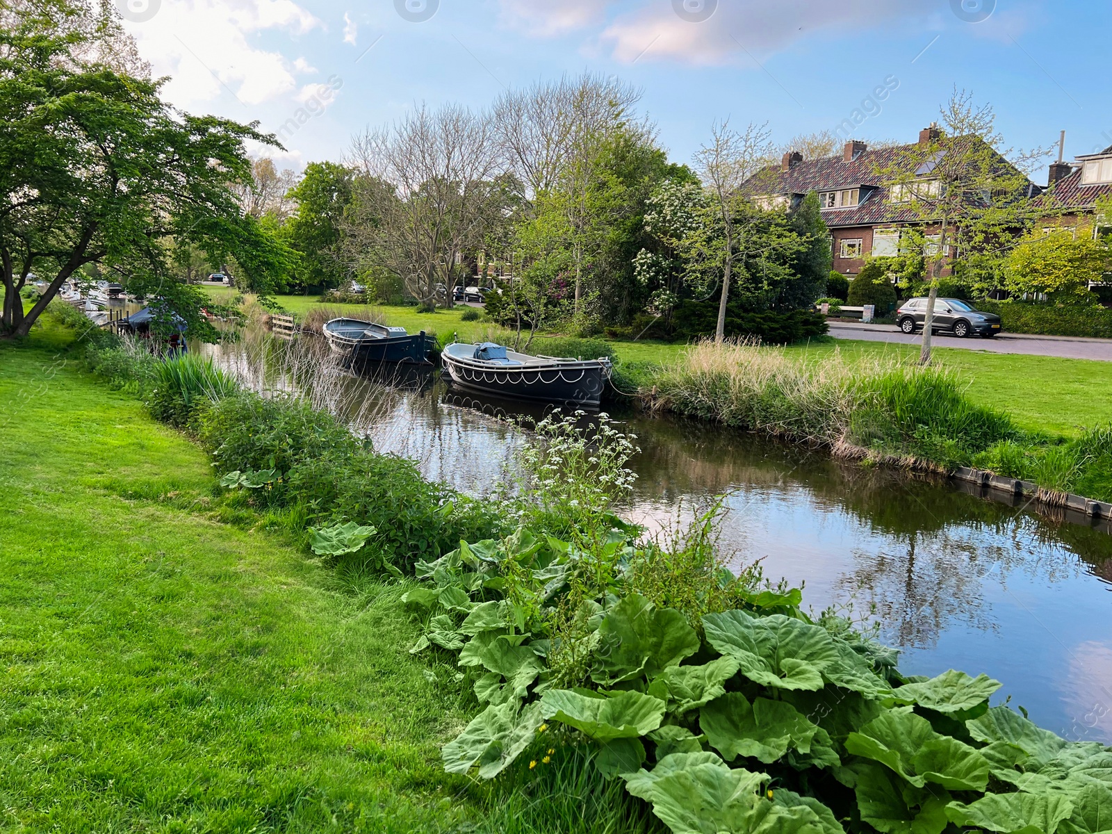 Photo of Beautiful city canal with moored boats on spring day