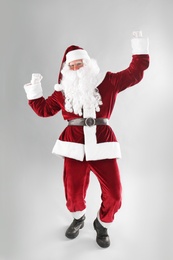 Full length portrait of Santa Claus on light grey background