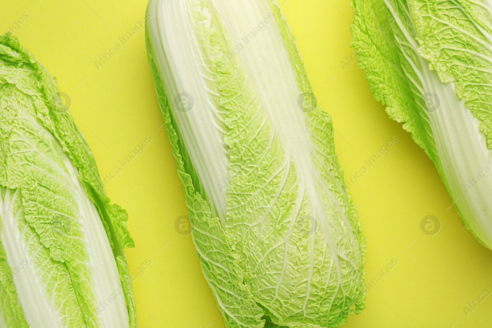 Photo of Fresh ripe Chinese cabbages on green background, top view