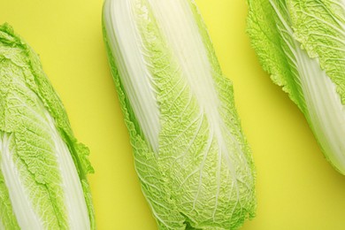 Photo of Fresh ripe Chinese cabbages on green background, top view