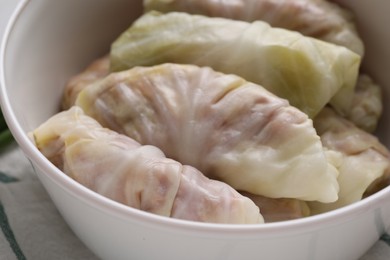 Photo of Uncooked stuffed cabbage rolls in pot, closeup