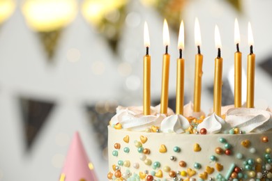Beautiful birthday cake with burning candles on blurred background, closeup. Space for text
