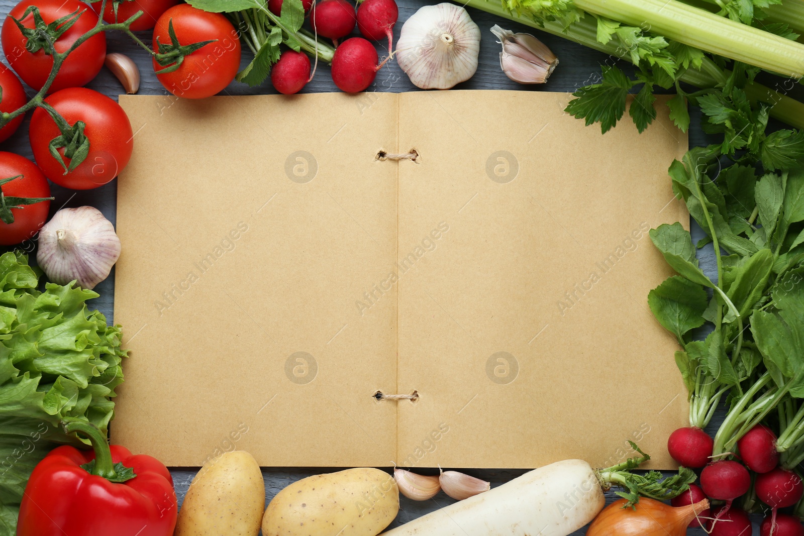 Photo of Blank recipe book and different ingredients on grey wooden table, flat lay. Space for text