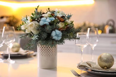 Photo of Beautiful winter bouquet on white table in kitchen